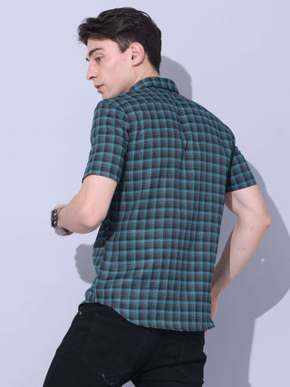 Green Check Casual Shirt shop online at Estilocus. The meticulous detailing of the check pattern adds a touch of refinement, creating a visual masterpiece that transcends simplicity.This regular collar,comfort fit,half sleeve, green checkered shirt can be