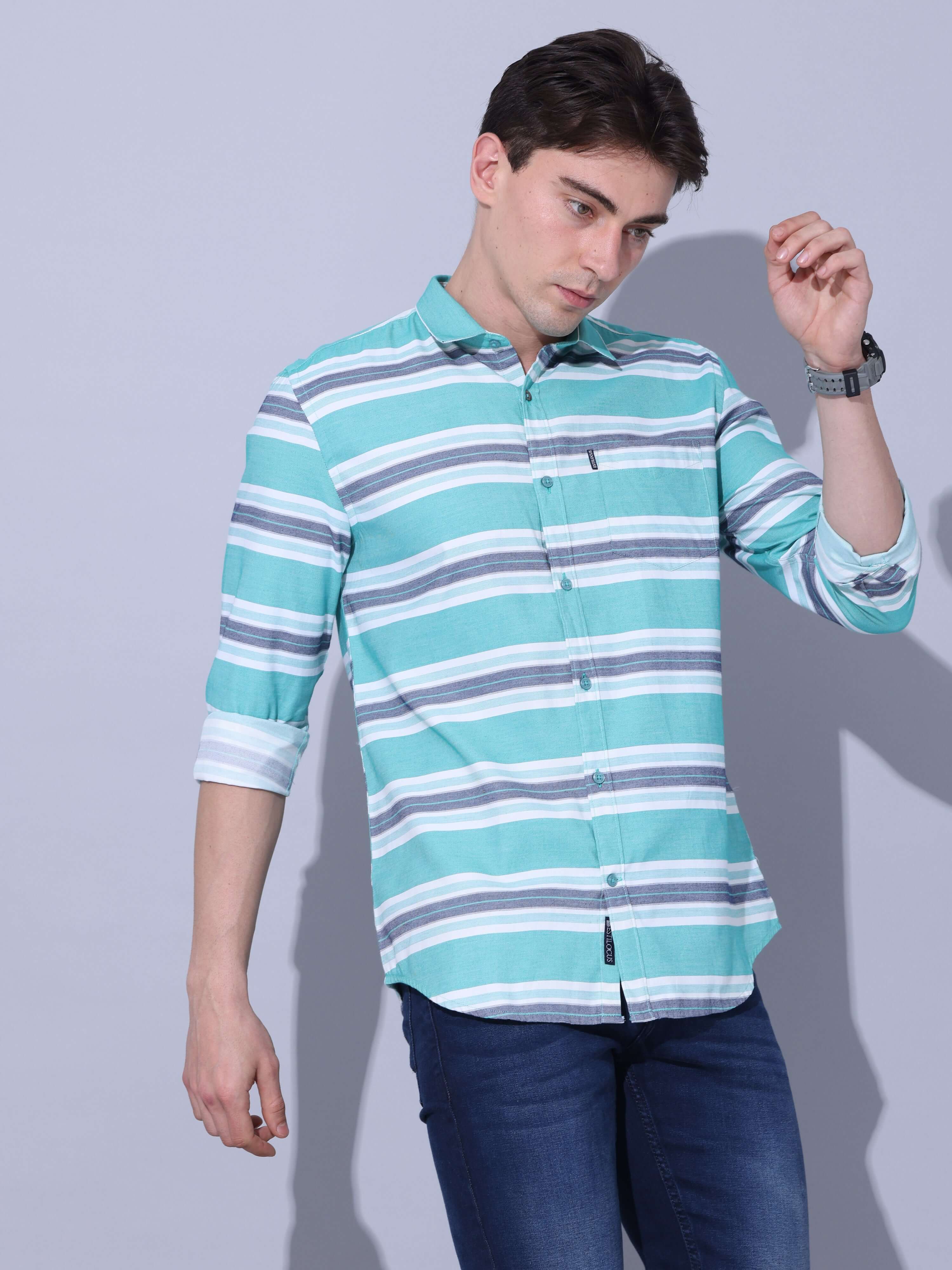 Green Stripe Casual Shirt shop online at Estilocus. •Geometric Stripe Print • Full sleeve shirt • Regular collar • Double button square cuff. • Single pocket with logo embroidery • Curved hemline • Finest quality sewing • Suitable to wear with all types o