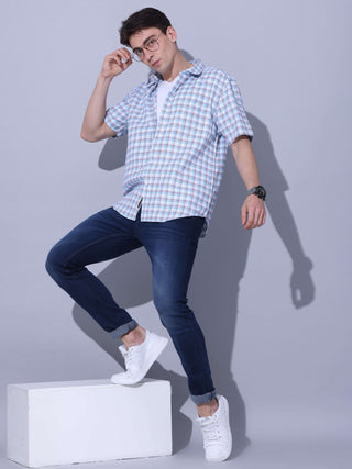 Light Blue Check Casual Shirt shop online at Estilocus. • Checkered half sleeve shirt with regular collar and curved hem. • Single pocket with logo embroidery • Finest quality sewing • Machine wash care • Suitable to wear with all types of bottoms • Made