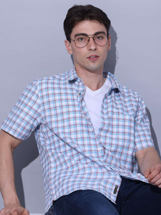 Light Blue Check Casual Shirt shop online at Estilocus. • Checkered half sleeve shirt with regular collar and curved hem. • Single pocket with logo embroidery • Finest quality sewing • Machine wash care • Suitable to wear with all types of bottoms • Made