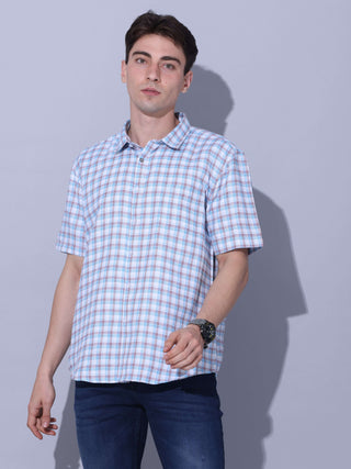 Light Blue Check Casual Shirt shop online at Estilocus. • Checkered half sleeve shirt with regular collar and curved hem. • Single pocket with logo embroidery • Finest quality sewing • Machine wash care • Suitable to wear with all types of bottoms • Made