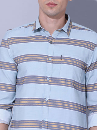 Powder Blue Stripe Casual Shirt shop online at Estilocus. •Powder blue full-sleeve stripe shirt • Cut and sew placket • Regular collar • Double button square cuff. • Single pocket with logo embroidery • Curved hemline • Machine wash care • Suitable to wea