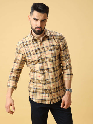 Man wearing a beige checkered slim-fit shirt, posing against a light background.